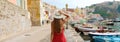 Holidays in Italy. Panoramic banner view of beautiful girl in stunning colorful harbor of Procida in Italy