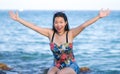 Holidays lifestyle portrait of young Asian woman by the  sea -  happy and beautiful Korean girl  enjoying beach vacation trip Royalty Free Stock Photo