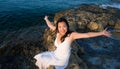 Holidays lifestyle portrait of young Asian woman by the  sea -  happy and beautiful Korean girl  enjoying beach vacation trip Royalty Free Stock Photo