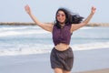 Holidays lifestyle portrait of young happy and attractive Asian Korean woman walking playful on beach enjoying the sea relaxed and Royalty Free Stock Photo