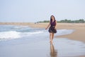 Holidays lifestyle portrait of young happy and attractive Asian Korean woman walking playful on beach enjoying the sea relaxed and Royalty Free Stock Photo