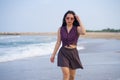 Holidays lifestyle portrait of young happy and attractive Asian Korean woman walking playful on beach enjoying the sea relaxed and Royalty Free Stock Photo