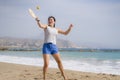 Holidays lifestyle portrait of young happy and cute Asian Chinese woman playing paddle ball holding racquet in the beach enjoying Royalty Free Stock Photo