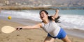 Holidays lifestyle portrait of young happy and cute Asian Japanese woman playing paddle ball holding racquet in the beach enjoying Royalty Free Stock Photo