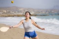 Holidays lifestyle portrait of young happy and cute Asian Japanese woman playing paddle ball holding racquet in the beach enjoying Royalty Free Stock Photo