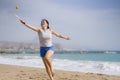 Holidays lifestyle portrait of young happy and cute Asian Korean woman playing paddle ball holding racquet in the beach enjoying Royalty Free Stock Photo