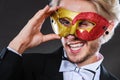 Young man in carnival mask on dark Royalty Free Stock Photo