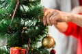 Close up of senior woman decorating christmas tree Royalty Free Stock Photo