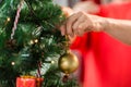 Close up of senior woman decorating christmas tree Royalty Free Stock Photo