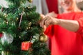 Close up of senior woman decorating christmas tree Royalty Free Stock Photo