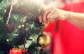 Close up of senior woman decorating christmas tree Royalty Free Stock Photo