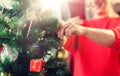 Close up of senior woman decorating christmas tree Royalty Free Stock Photo