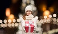 Happy girl in winter clothes with gift box Royalty Free Stock Photo