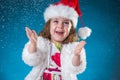 holidays, presents, christmas, childhood concept - smiling little girl over blue background Royalty Free Stock Photo