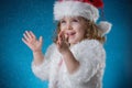 holidays, presents, christmas, childhood concept - smiling little girl over blue background. Royalty Free Stock Photo