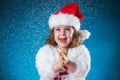 holidays, presents, christmas, childhood concept - smiling little girl over blue background. Royalty Free Stock Photo