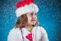 holidays, presents, christmas, childhood concept - smiling little girl over blue background. Royalty Free Stock Photo