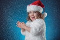 holidays, presents, christmas, childhood concept - smiling little girl over blue background. Royalty Free Stock Photo