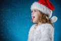 holidays, presents, christmas, childhood concept - smiling little girl over blue background. Royalty Free Stock Photo