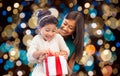 Happy mother and daughter girl with gift box Royalty Free Stock Photo