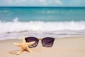 Holidays. sand beach, sunglasses and starfish