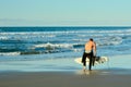 Papamoa Beach, Papamoa, New Zealand, July 07, 2019: an unidentified surfer preparing to enter the sea.