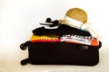 Holidays suitcase with clothes, hat sunglasses Royalty Free Stock Photo
