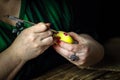 Holidays, traditional concept - close up of woman hands coloring Easter eggs with brush. Preparation for Easter. Close-up