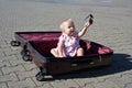 Holidays and travel conceipt: a toddler girl sitting in a suitca