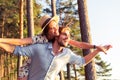 Holidays, vacation, love and friendship concept - smiling couple having fun over sky background. Royalty Free Stock Photo