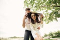 Holidays, vacation, love and friendship concept - smiling couple in sunglasses having fun in summer park Royalty Free Stock Photo