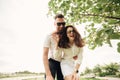 Holidays, vacation, love and friendship concept - smiling couple in sunglasses having fun in summer park Royalty Free Stock Photo