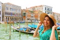 Holidays in Venice! Beautiful woman with straw hat smiling at camera with Venice Grand Canal, gondolas and palaces Royalty Free Stock Photo