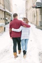 Holidays, winter, christmas, hot drinks and people concept - happy couple in warm clothes having fun, hugging in winter Royalty Free Stock Photo