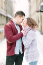 Holidays, winter, christmas, hot drinks and people concept - happy couple in warm clothes having fun, hugging and Royalty Free Stock Photo