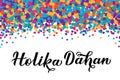 Holika Dahan calligraphy lettering with colorful dots confetti. Indian Traditional Holi festival of colors. Hindu celebration Royalty Free Stock Photo