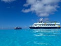 The Holland America Line Zuiderdam cruise ship anchored off the private island of Half Moon Cay in the Bahamas on a sunny day with Royalty Free Stock Photo
