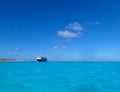 The Holland America Line Zuiderdam cruise ship anchored off the private island of Half Moon Cay in the Bahamas on a sunny day with Royalty Free Stock Photo