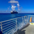 The Holland America Line Zuiderdam cruise ship anchored off the private island of Half Moon Cay in the Bahamas on a sunny day with Royalty Free Stock Photo