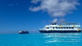 The Holland America Line Zuiderdam cruise ship anchored off the private island of Half Moon Cay in the Bahamas on a sunny day with Royalty Free Stock Photo