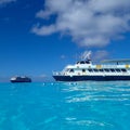 The Holland America Line Zuiderdam cruise ship anchored off the private island of Half Moon Cay in the Bahamas on a sunny day with Royalty Free Stock Photo