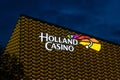 Holland Casino Utrecht in the Netherlands illuminated sign, illuminated building. Golden facade with colorful logo sign