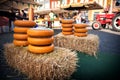 Holland cheese rounds displayed on hay stack at traditional market Royalty Free Stock Photo