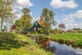 Holland countryside landscape with traditional dutch windmills and authentic houses in the historic village of Zaanse Schans. Royalty Free Stock Photo