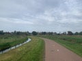 Holland dutch cycling path village meadow ditch clouds