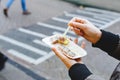 Holland herring fish in female hand outside. Traditional Dutch street food, herring fish. Stock photo street food, herring fish Royalty Free Stock Photo