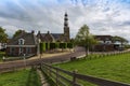 Holland - Hindeloopen - coast, high coastal wall overgrown with grass. in the middle of the path leads to the houses and the way Royalty Free Stock Photo