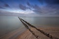 Holland - An old, dilapidated, wooden breakwater, begins on the edge of a sandy beach and ends in the sea. For a long time calmed