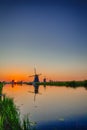 Holland Traveling. Line of Distant Traditional Dutch Windmills in the Village of Zaanse Schans at Daytime in the Netherlands Royalty Free Stock Photo