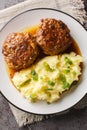 Hollandse Gehaktballen Dutch large Meat Balls served with mashed potatoes and gravy closeup on the plate. Vertical top view